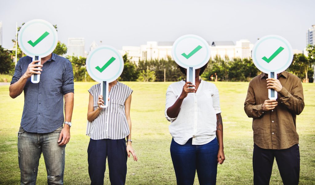 Diverse friends holding checkmark icons