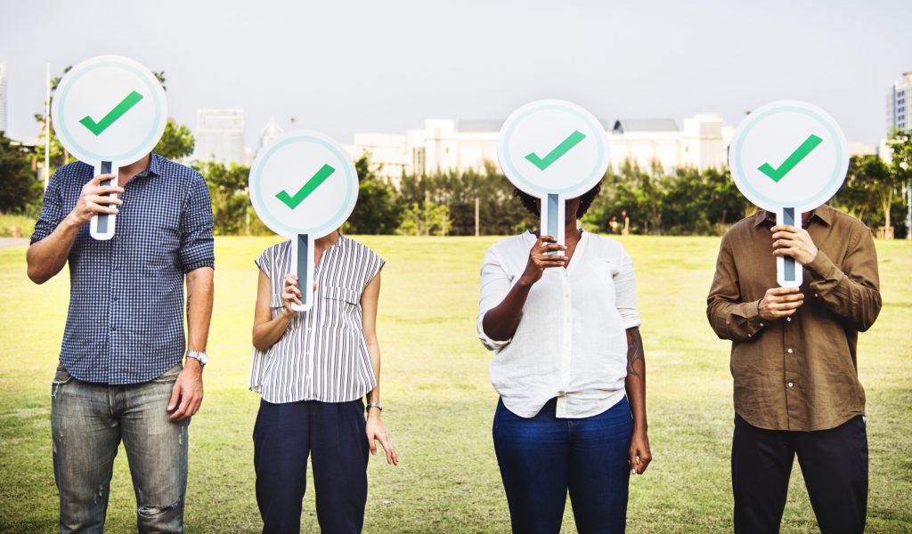 Diverse friends holding checkmark icons
